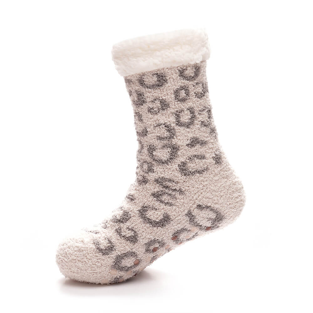 grey animal print lounge socks with sherpa trim on foot with grippers on the base