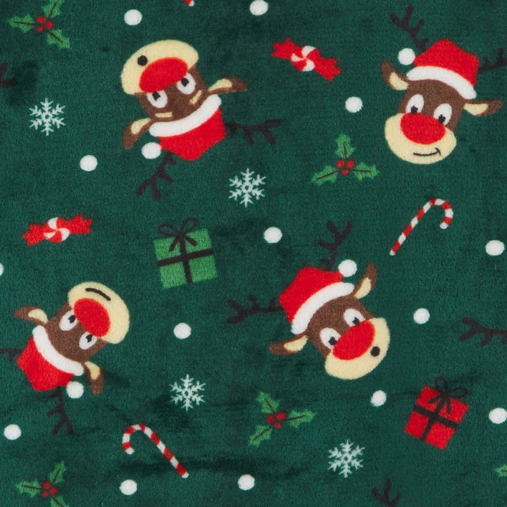 Close up of dark green fleece Christmas reindeer, holly, snowflakes and candy canes pattern