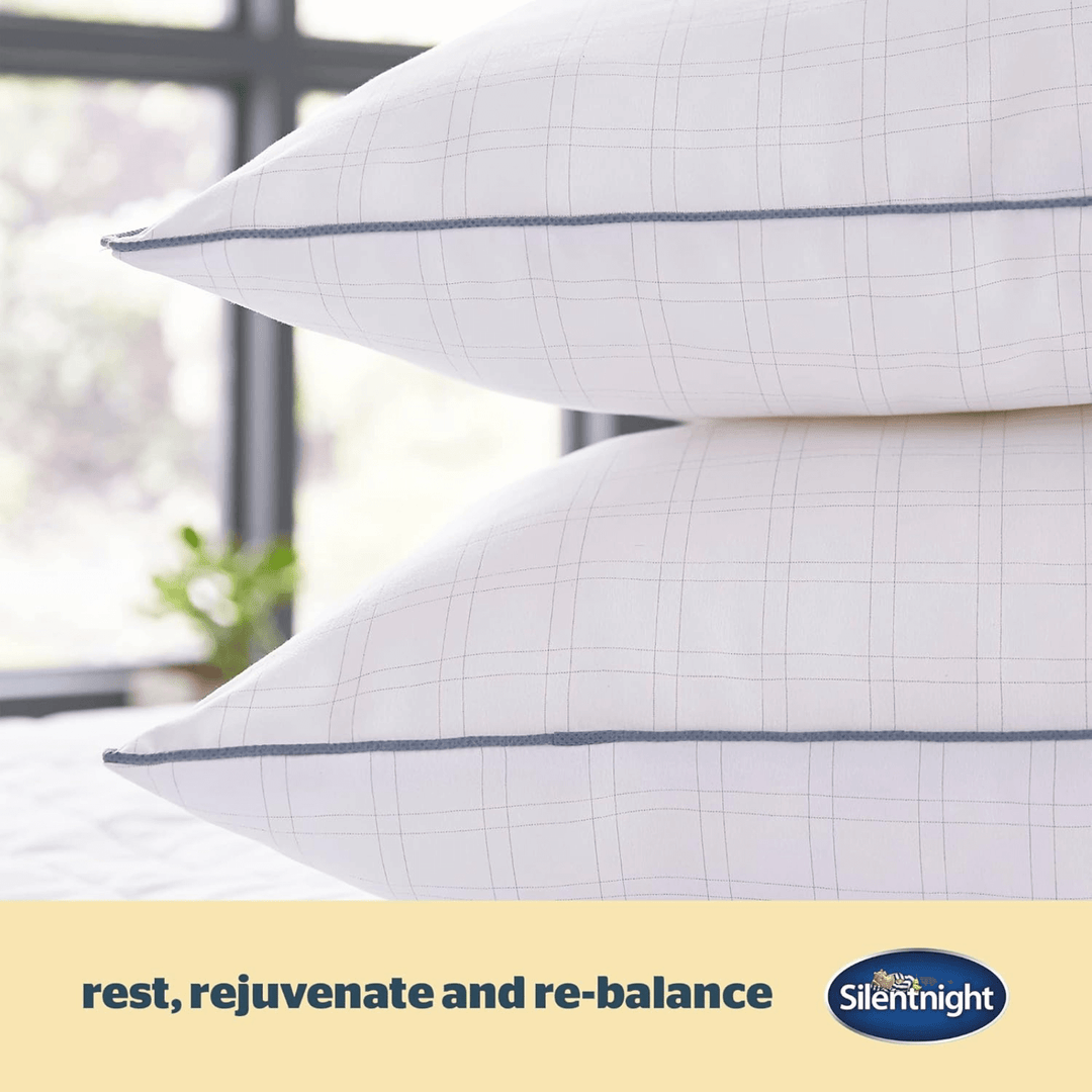 detail shot of grey carbon thread on pillow with "rest, rejuvenate and re-balance" details on graphic beside silentnight logo