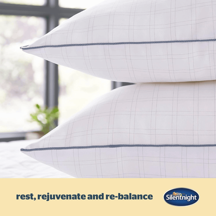 detail shot of grey carbon thread on pillow with "rest, rejuvenate and re-balance" details on graphic beside silentnight logo