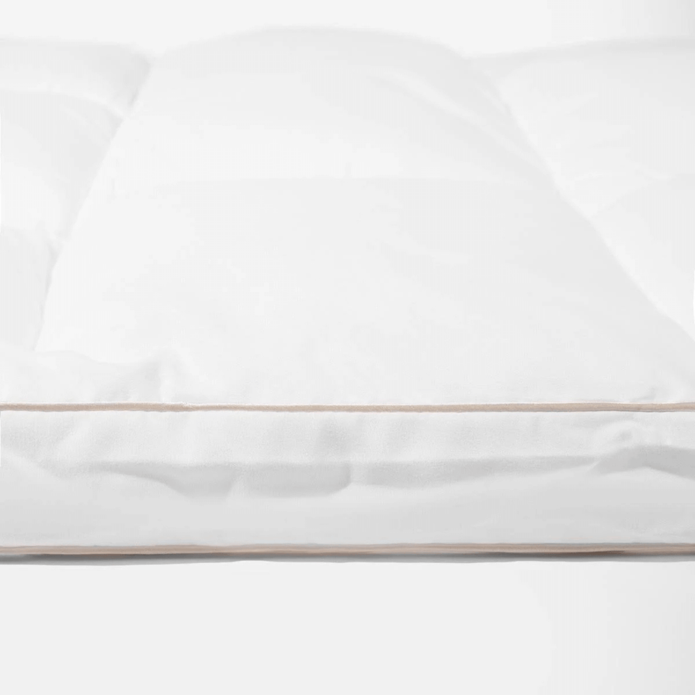 White topper with a thin gold stripe on a white background