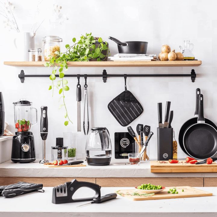 kitchen shot of masterchef kitchen essentials including pots and pans, spatulas and kitchen scales