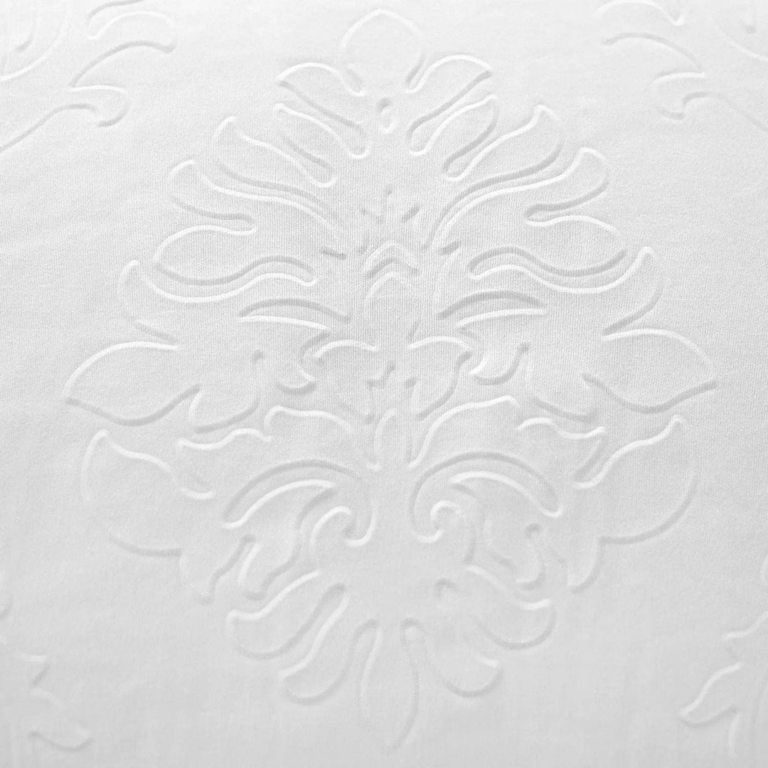 Detail of white embossed floral foliage pattern on a Jeff Banks pillow