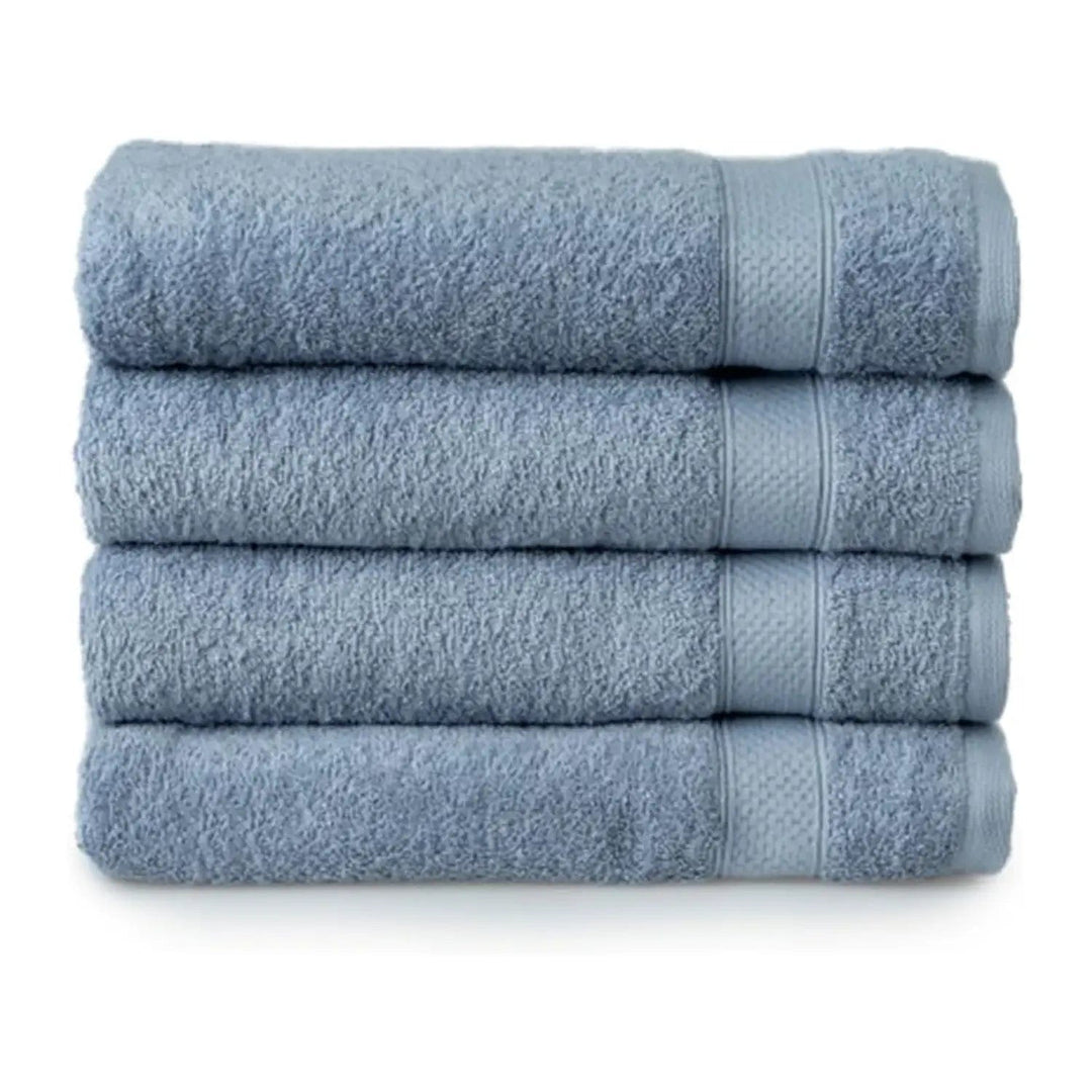 Set of 4 dusty blue bath towels folded in a pile