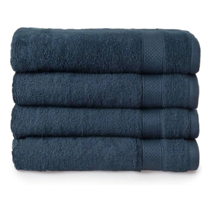 Set of 4 dark navy blue bath towels folded in a pile