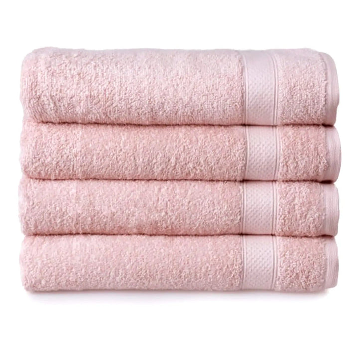 Set of 4 blush pink bath towels folded in a pile