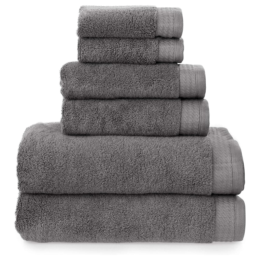 6 charcoal grey towels folded in a pile with 2 baht towels, 2 hand towels and 2 face cloths