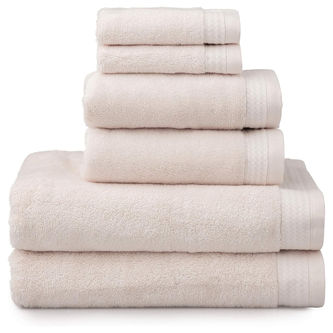 6 blush pink towels folded in a pile with 2 baht towels, 2 hand towels and 2 face cloths