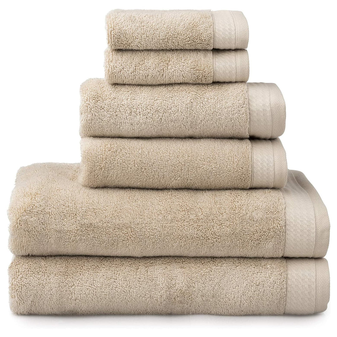 6 almond beige towels folded in a pile with 2 baht towels, 2 hand towels and 2 face cloths