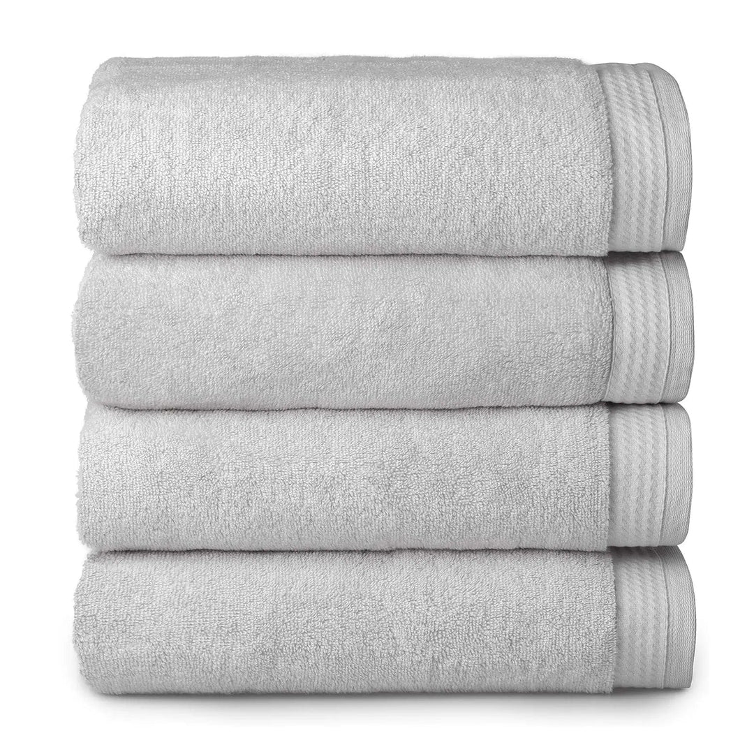 4 thick luxury silver grey towels folded and piled up