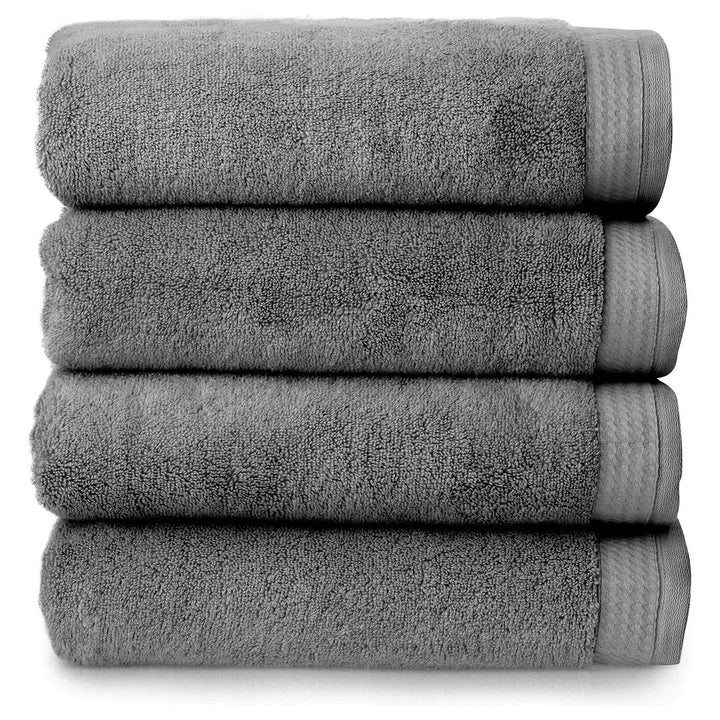 4 thick luxury charcoal grey towels folded and piled up