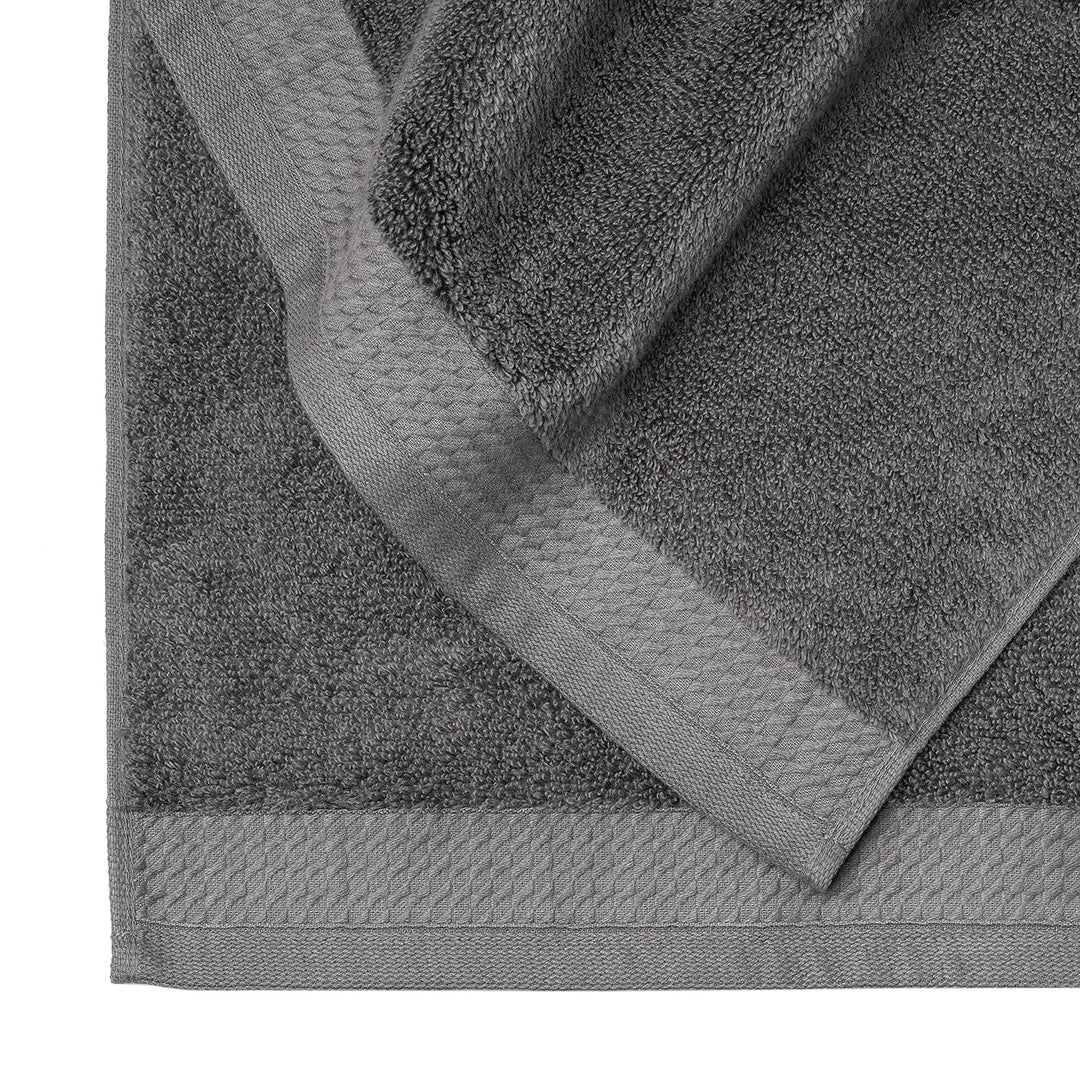 Close up detail of stitched edging on a luxury dark grey towel