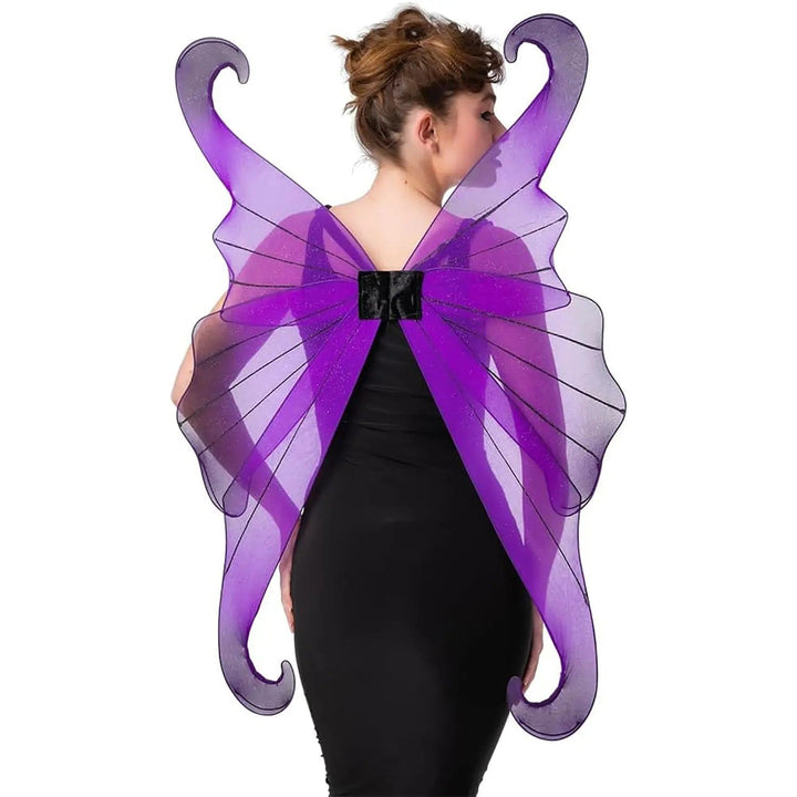 Female model wearing large purple and black fairy wings with a black dress