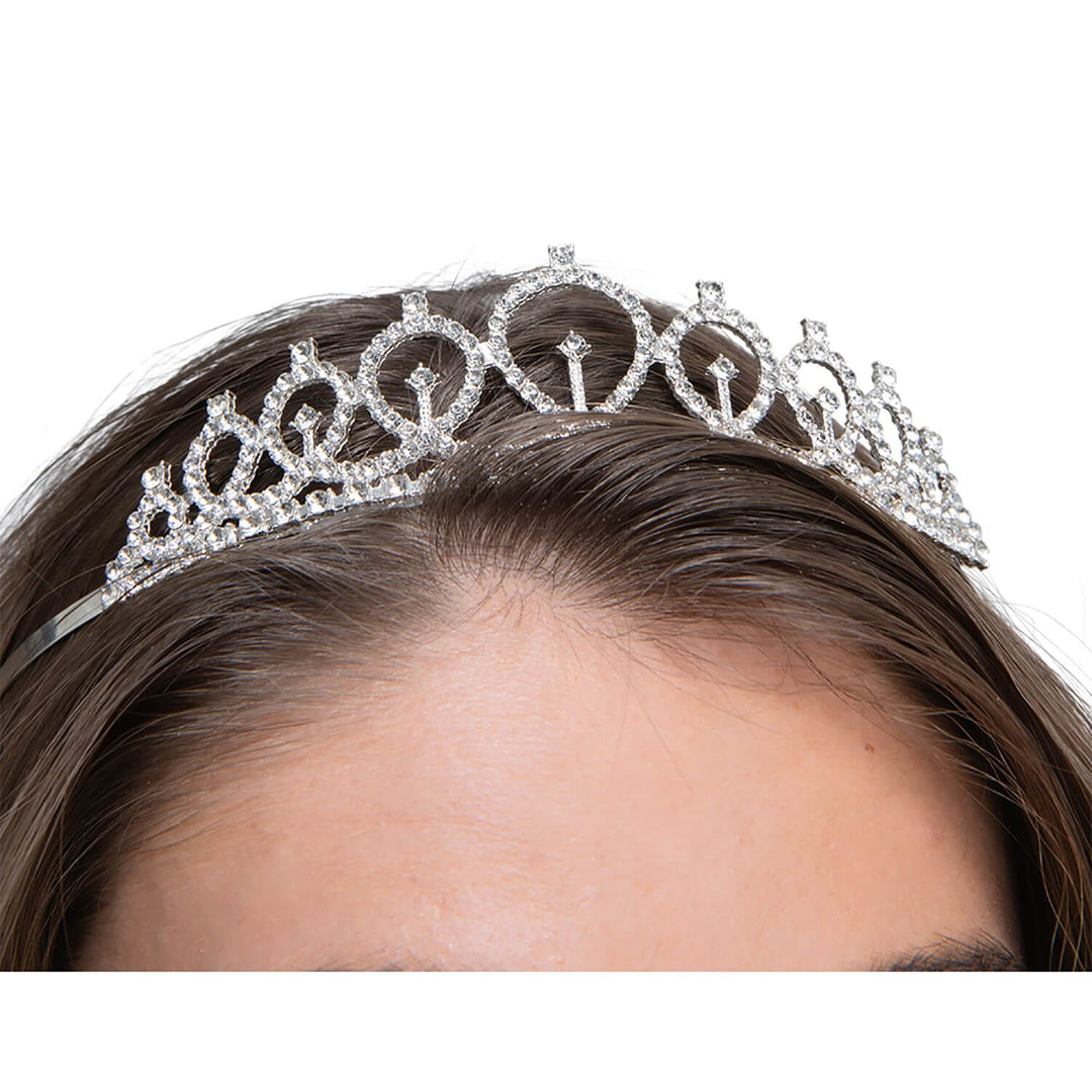 Close up of a silver diamond tiara with loops and a silver headband