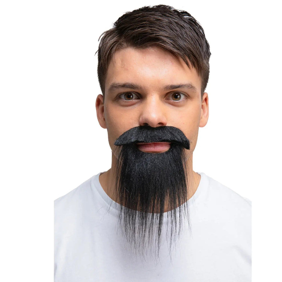 Young man wearing a black moustache and beard for fancy dress costumes