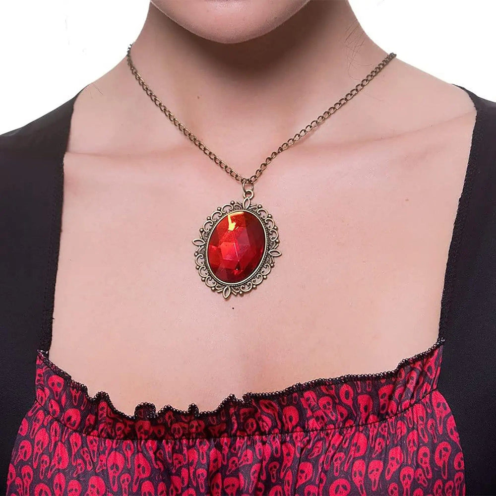 Cose up of large red jewel pendant in silver setting for vampiress fancy dress costumes