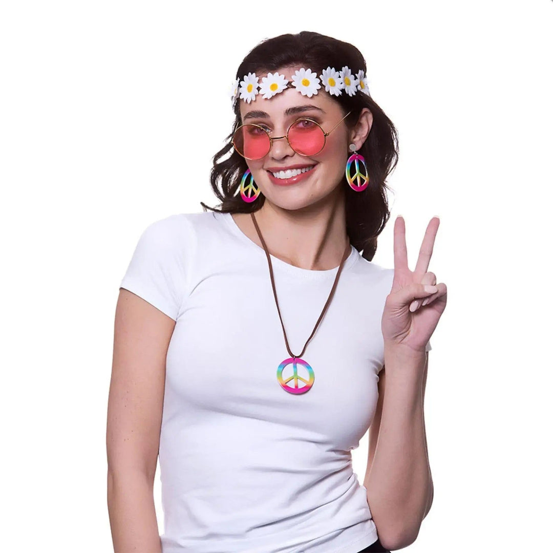 Woman wearing daisy headband, pink tinted glasses, CND symbol earrings and necklace