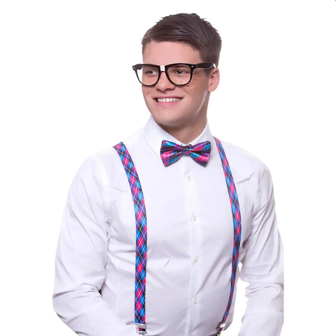 Man wearing black rimmed glasses, white shirt with ink and purple check bow tie and matching braces