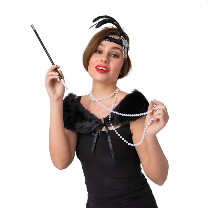 Lady wearing a Flapper Girl accessories set with black feather headband, shawl, pearls and cigarette holder