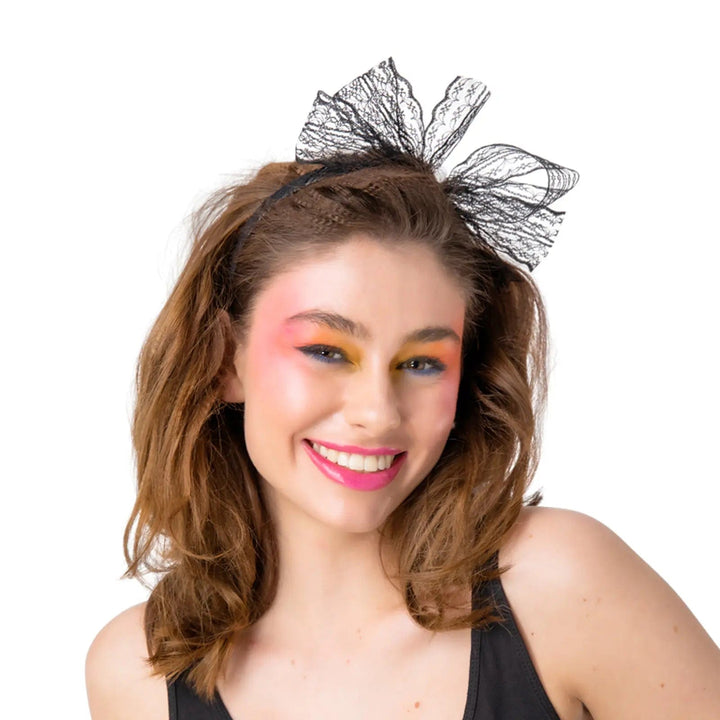 Lady wearing a black lace hair bow on a headband for 1980s fancy dress parties