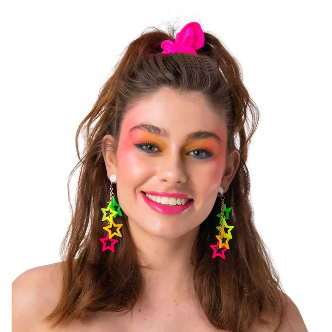 Young lady wearing a pair of neon star drop earrings for 80s fancy dress costumes