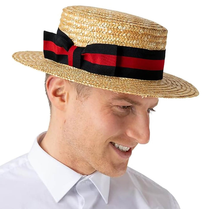 A man wearing a straw boater hat with a black and red striped ribbon band and bow for fancy dress costumes.