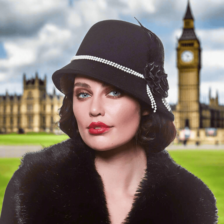 Lady wearing a black cloche hat with black rose and pearls for 1920s fancy dress costumes