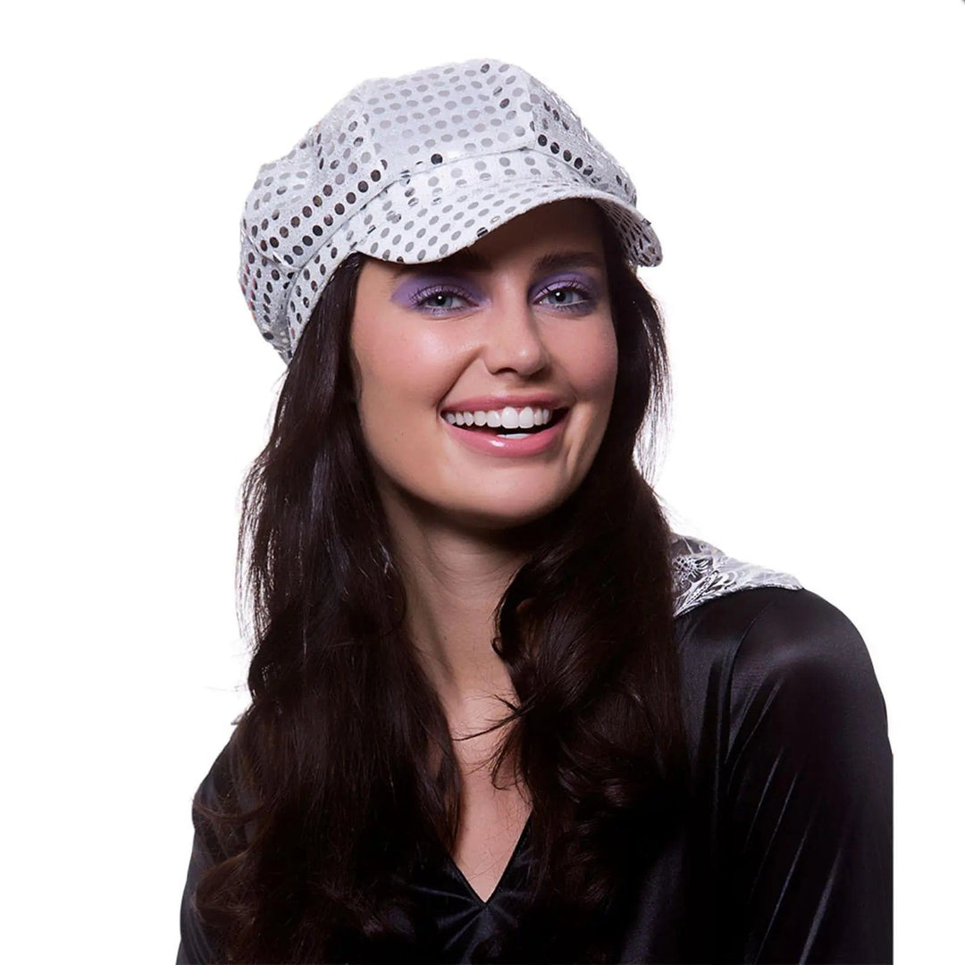 Lady with long black hair wearing a 1970s silver baker boy style hat for fancy dress parties