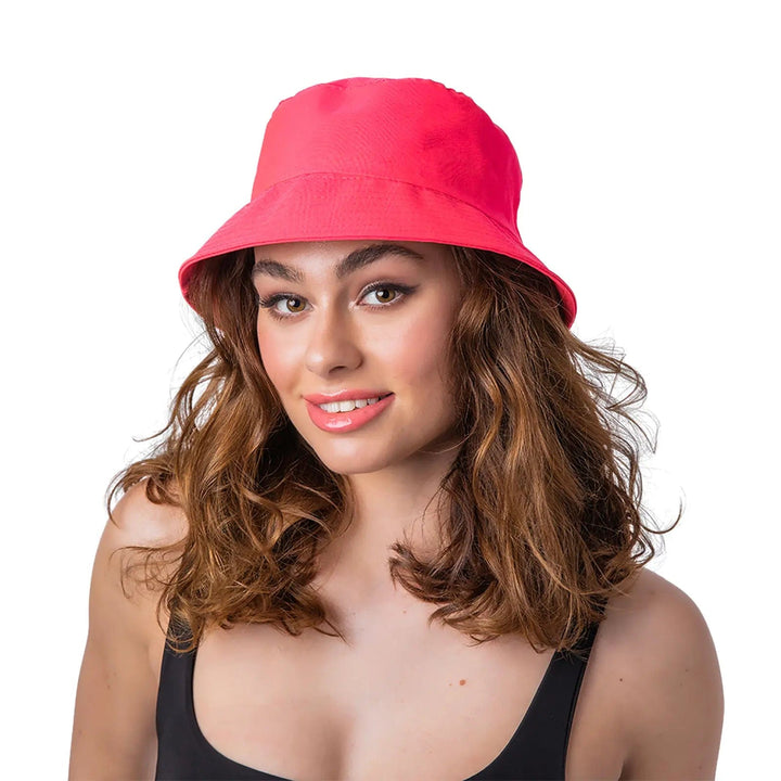 Lady wearing a bright neon pink retro bucket hat for 1980s theme fancy dress costumes