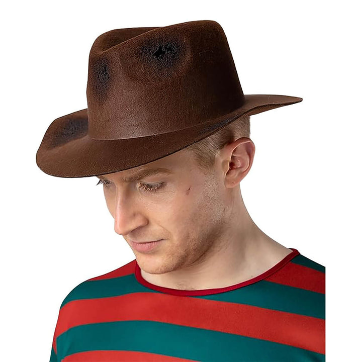 Man wearing a brown fedora style hat with worn patches and holes for Freddie Nightmare fancy dress costumes