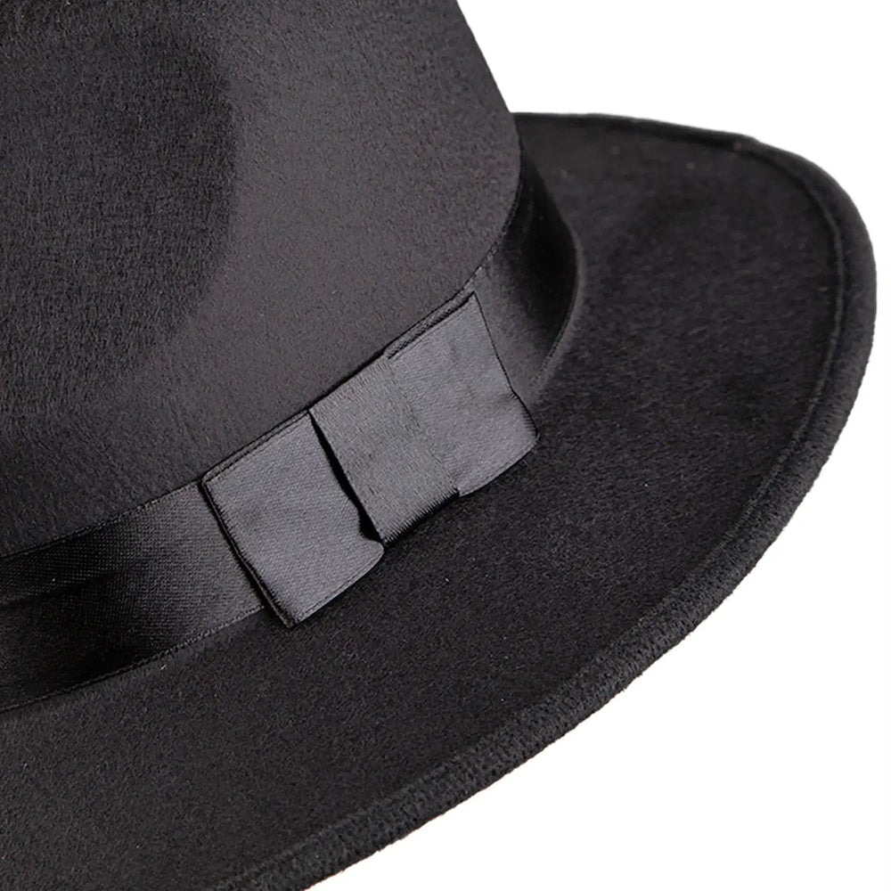 Close up of black satin bow on a fedora hat band for fancy dress costumes