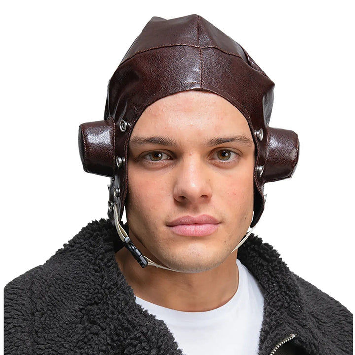 Man wearing a 1940s fighter pilot hat in dark brown faux leather with chin strap for fancy dress costumes