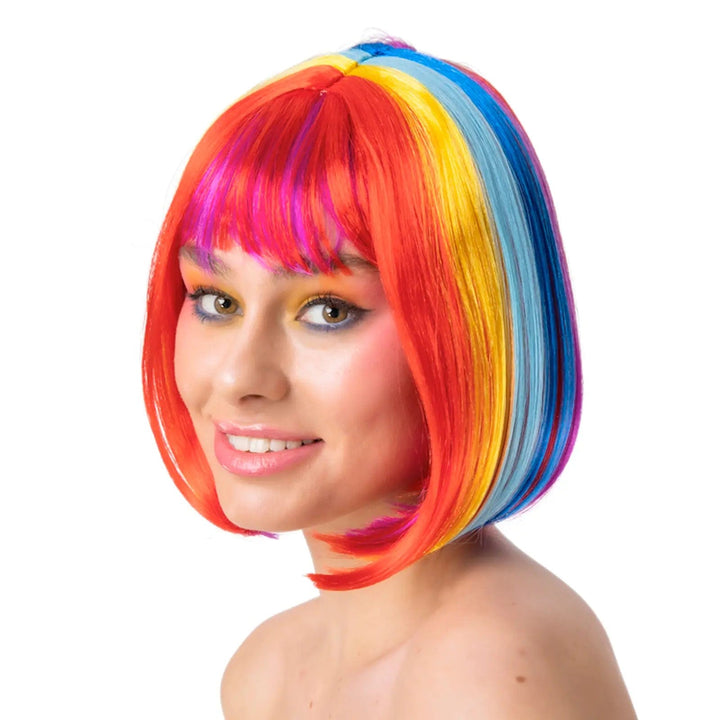 Female model wearing a rainbow coloured wig in a pageboy style bob with fringe for Pride festivals and fancy dress costumes