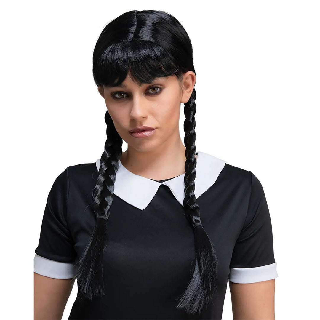 Woman wearing a black wig with braided pigtails for Wednesday Addams fancy dress costume