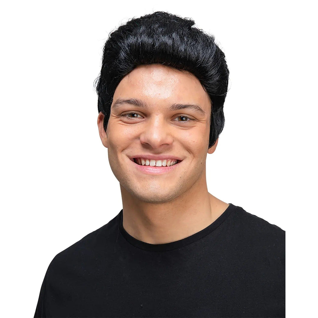 Man wearing a black t-shirt and a black slicked back wig for 1950s rocker fancy dress costumes