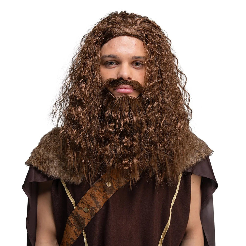 Man dressed in a medieval tunic with long curly brown hair wig and beard for fancy dress parties