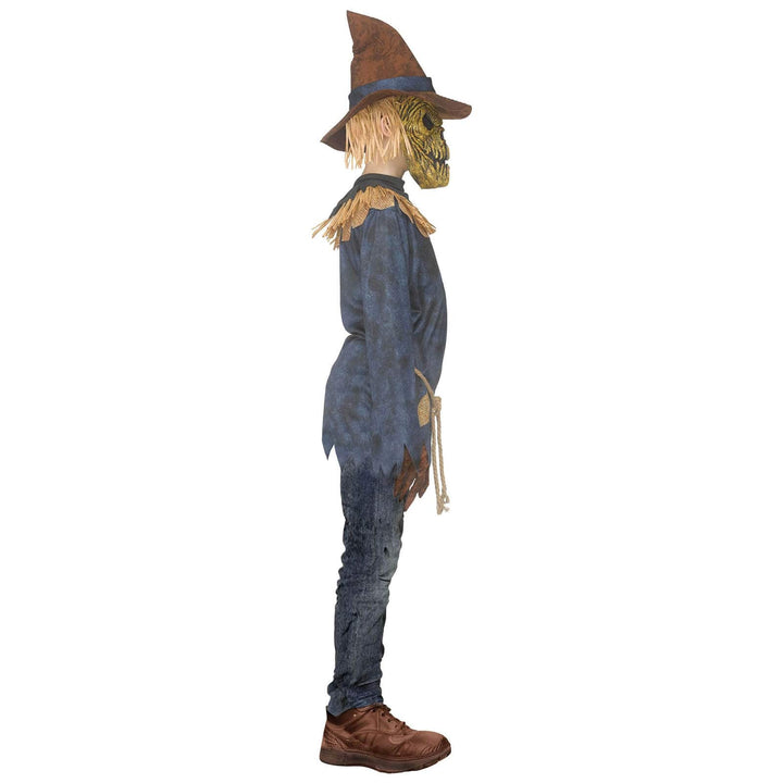 A scarecrow Halloween decoration shown in profile against a plain white background. The scarecrow has a brown hat, a straw blonde head, a weathered blue shirt, blue jeans, and brown shoes.