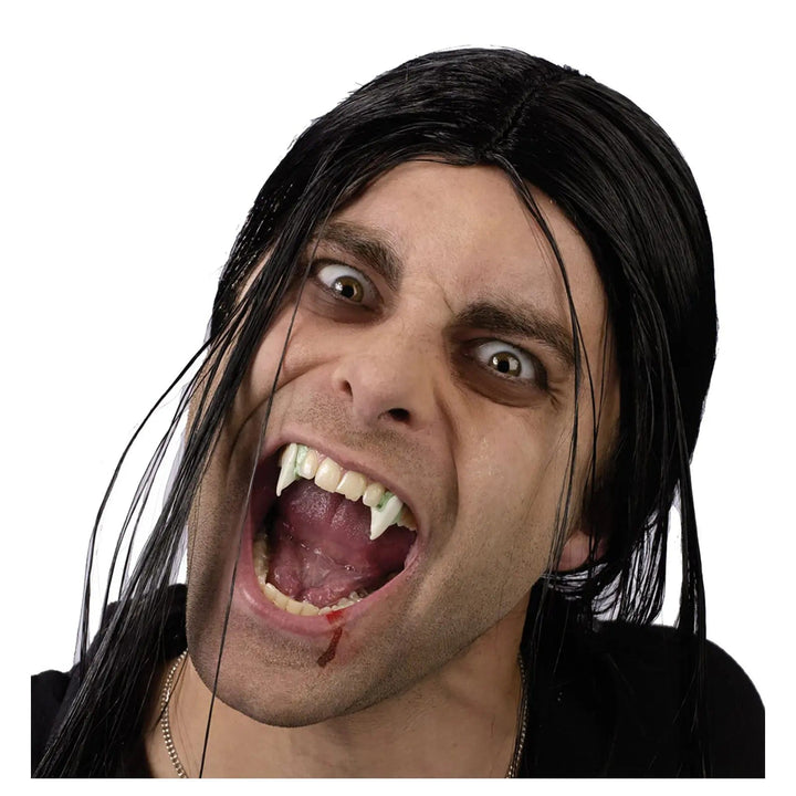 Man with mouth open to show vampire fangs with fake blood