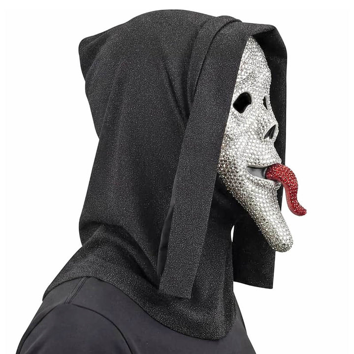 A person wearing a black hooded Scary Movie costume mask with a silver rhinestone-embellished face and a red rhinestone tongue, shown against a plain white background.