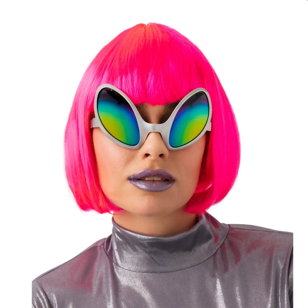 Model waering a neon pink wig and alien sunglasses with rainbow lenses for fancy dress costumes