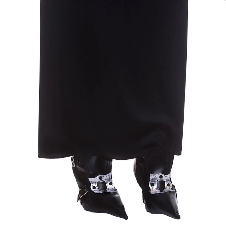 Person wearing a pair of black witch shoe covers with silver buckle detailing