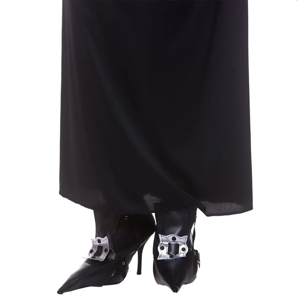 Person wearing a pair of black witch shoe covers with silver buckle detailing