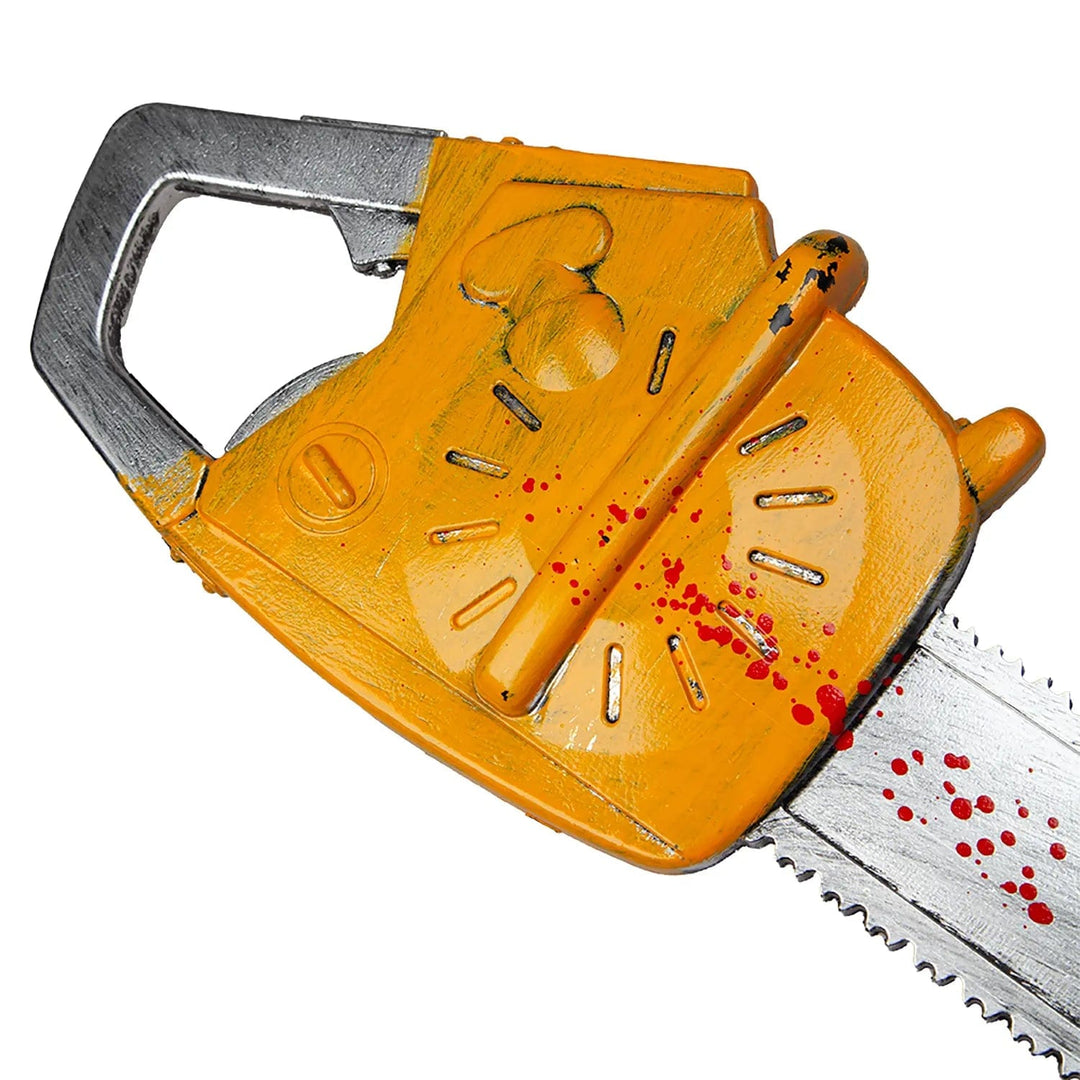 Close up of the yellow engine housing on a plastic chainsaw Halloween prop with blood stains