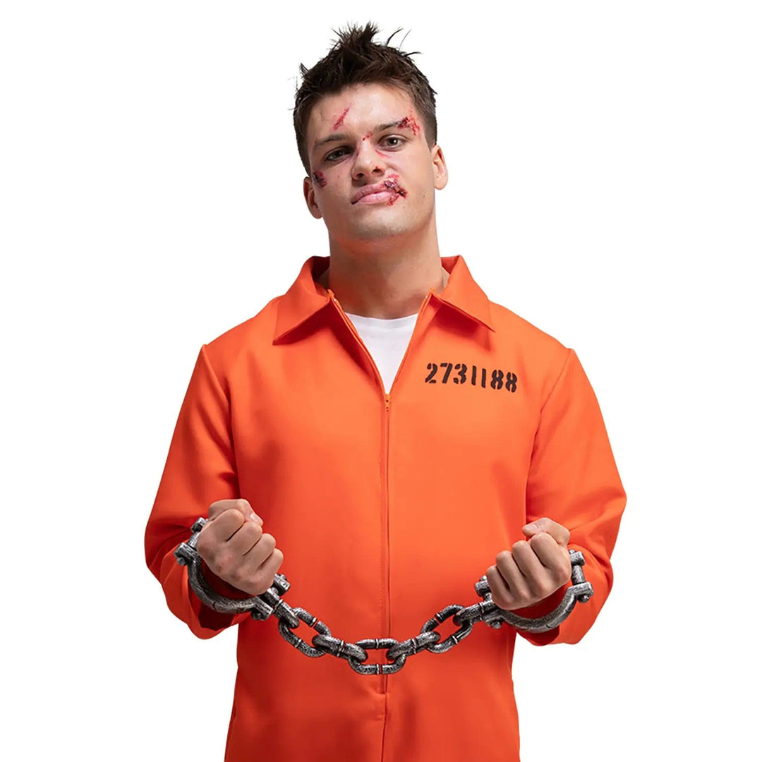 Man wearing an orange convict costume with shackles on his wrists