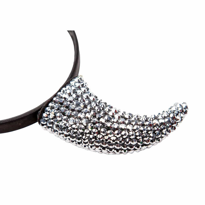 Close up of a devil horn costume accessory covered with silver rhinestones