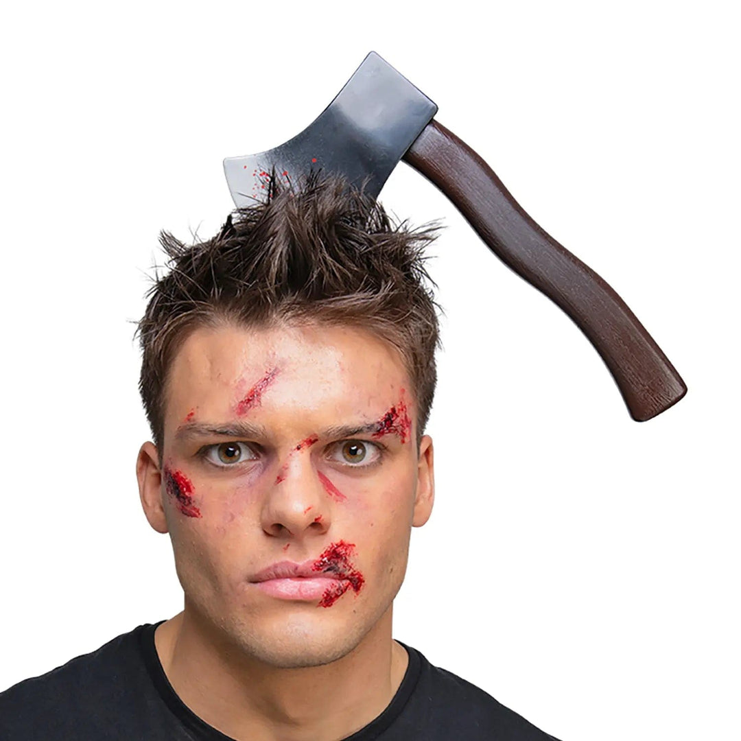 Man with horror makeup and wearing an axe prop headband for Halloween zombie fancy dress costumes