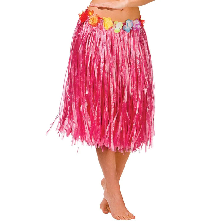 Woman wearing a bright pink Hawaiian hula skirt with flower waist band