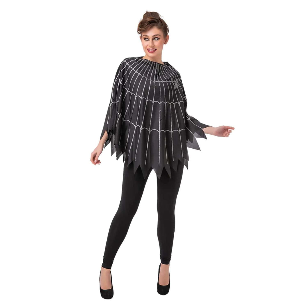 Lady wearing a black spider web poncho with silver spider and black leggings