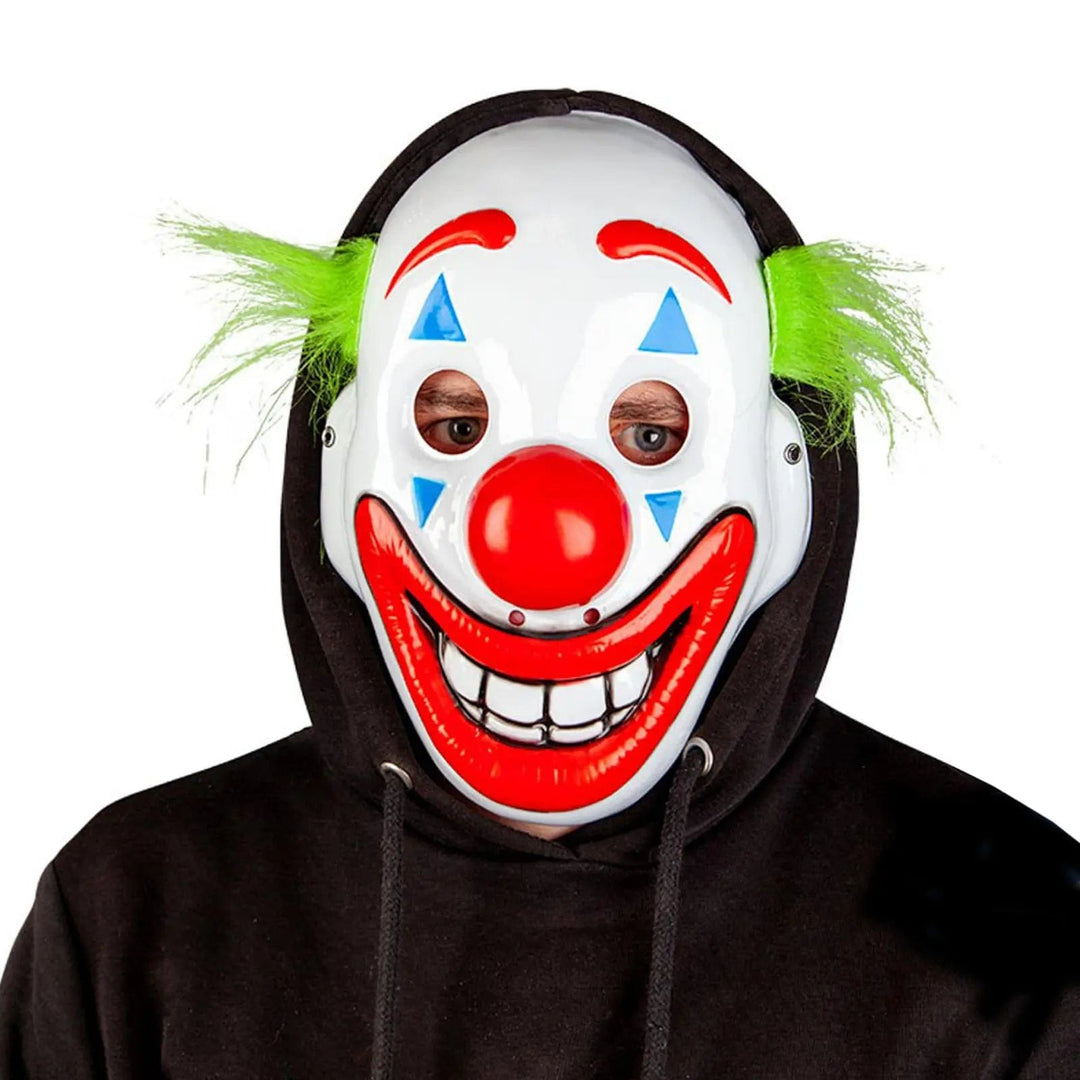 Happy face clown mask with green tufts of hair, big smiling mouth and red nose for Halloween and fancy dress costumes