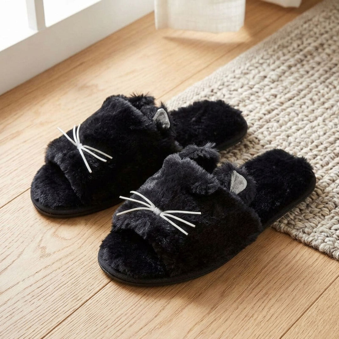 black faux fur kitty slider slippers with 3d whiskers on wooden floor with jute rug in background